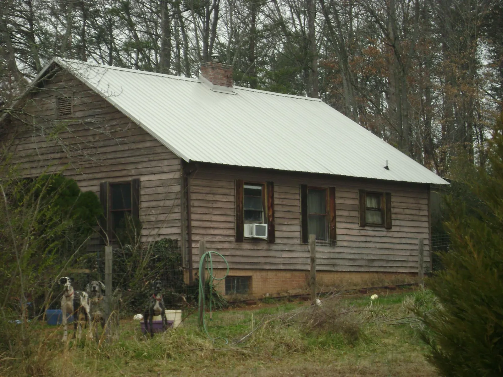 White metal roof on an old wood sided farmhouse, from a Metal Roof Installation job in Mayview